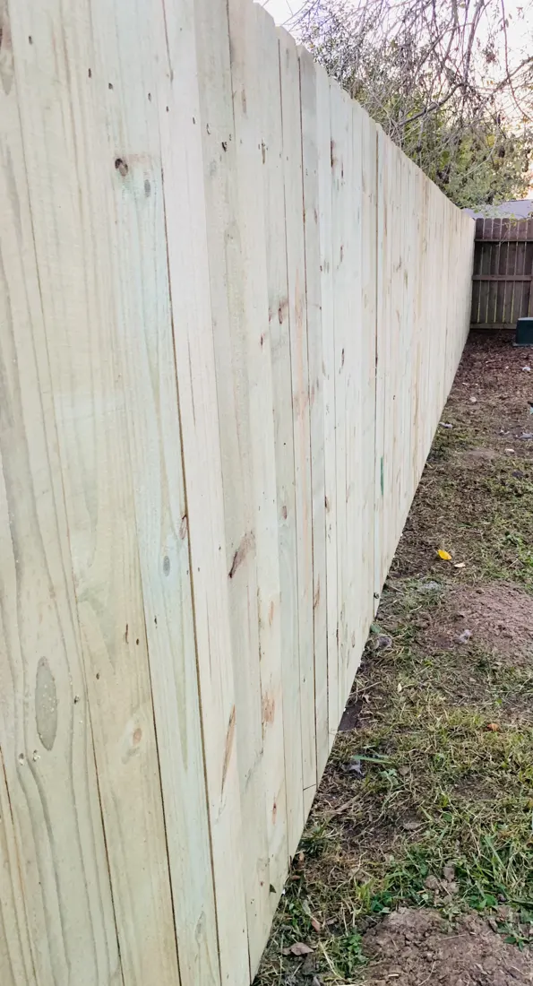 A wood privacy fence seen along its length